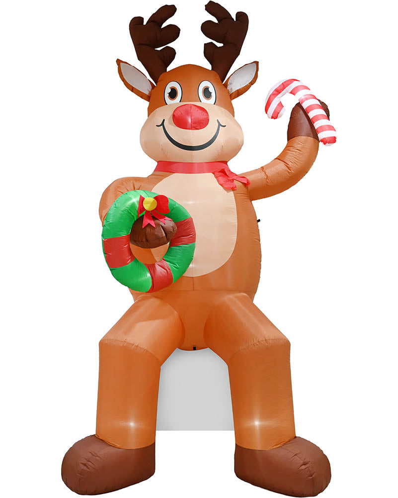Inflatable Christmas reindeer decoration with brown antlers and legs, a red nose, a red scarf, a green wreath with a bell, and a red-and-white striped candy cane, shown on a plain white background.