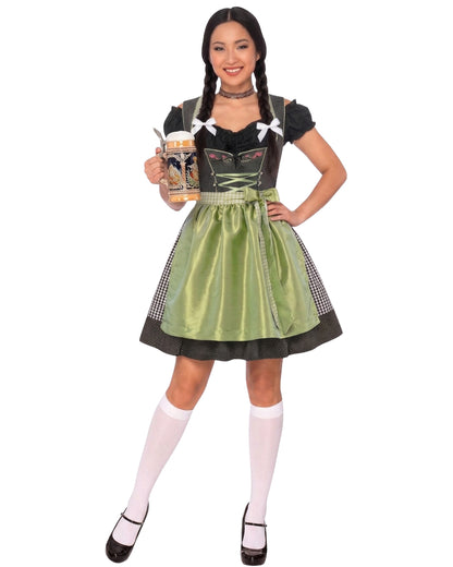 A woman modeling a traditional German dirndl costume against a plain white background. The costume features a black bodice with white lace-up details, a shiny olive green skirt, and black-and-white checkered side panels.