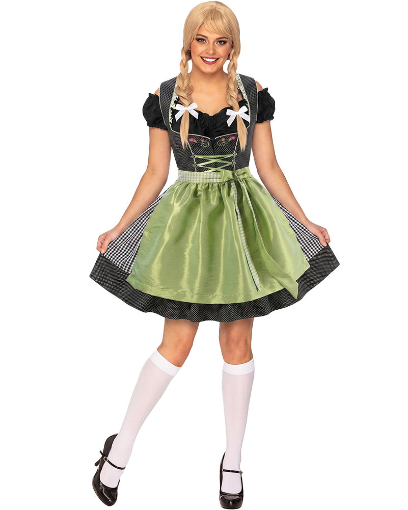 A woman modeling a traditional German dirndl costume against a plain white background. The costume features a black bodice with white bow details, a green satin skirt, and black-and-white gingham side panels.