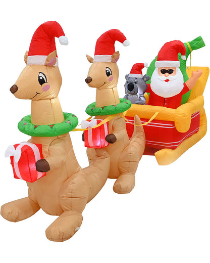 Inflatable Christmas decoration featuring two kangaroo figures wearing Santa hats and green wreaths, pulling a Santa Claus sleigh with a koala on a white background.