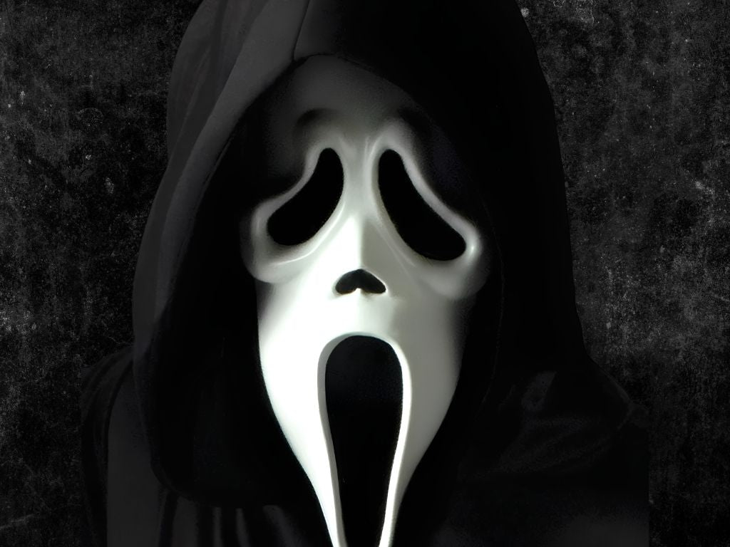 Close-up view of the iconic Ghostface mask from the movie Scream worn under a black hooded robe against a dark textured background. Click to shop all Scream Ghostface Costumes.