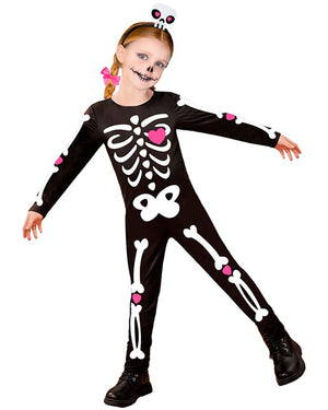 Child wearing a skeleton costume with pink accents on a white background