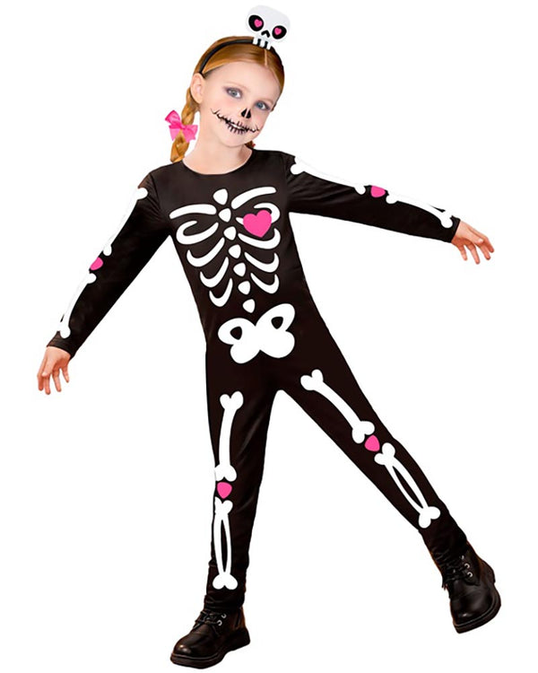 Child wearing a skeleton costume with pink accents on a white background