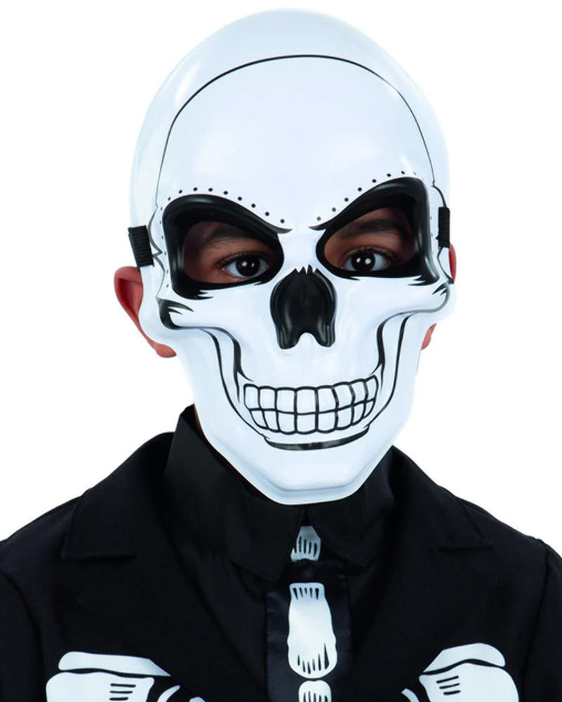 A child wearing a white skeleton design half mask with eye openings, and black clothing.