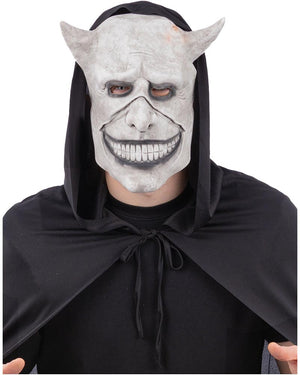 Person wearing a gargoyle mask with a black hood and cape on a white background