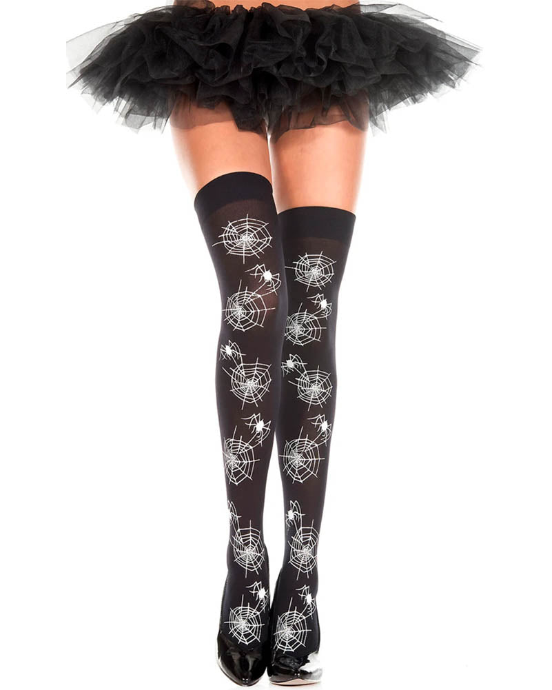 Black thigh-high stockings with a white spiderweb and spider print pattern, shown on a model's legs with a black ruffled tutu skirt and black shoes against a white background.