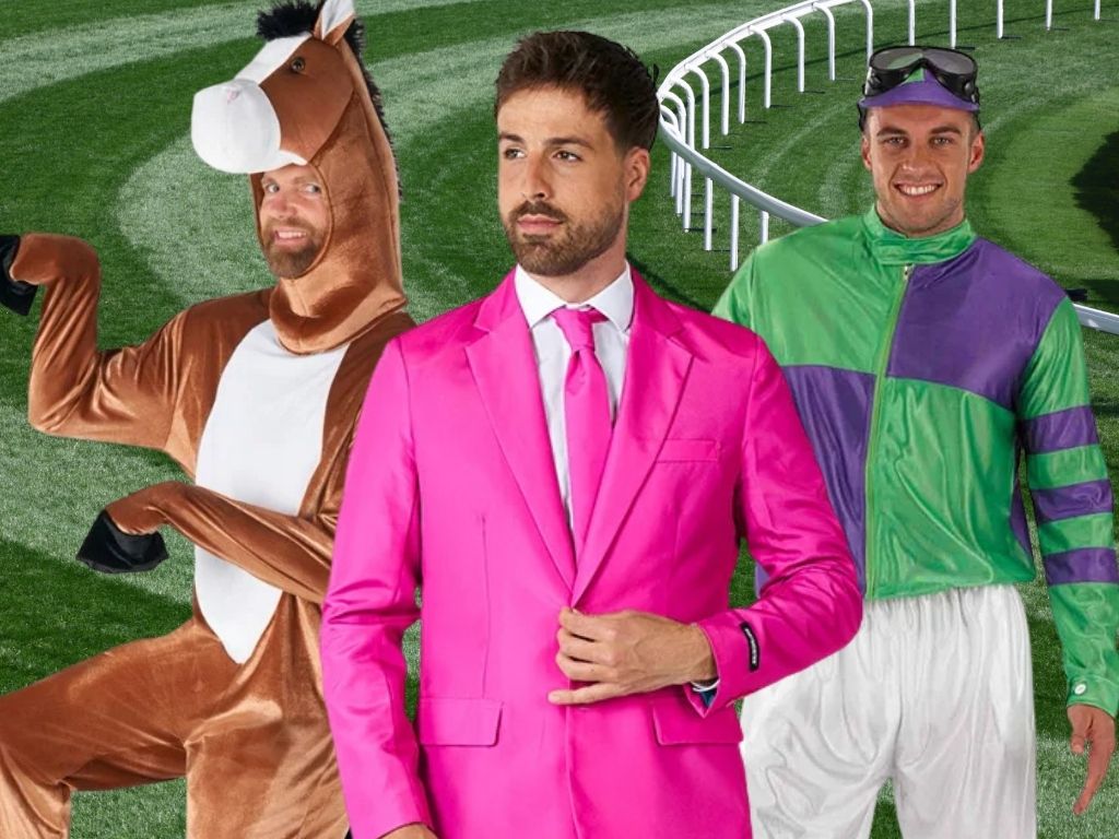 Three men standing on a racecourse track wearing Spring Racing Carnival costumes: one in a brown horse suit, one in a bright pink suit with matching tie, and one in a purple and green jockey costume. Click to shop all Spring Racing.