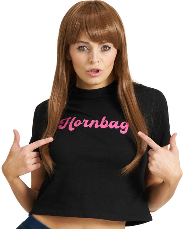 Woman wearing a brown wig with black t-shirt with 'Hornbag' in pink text, pointing at herself.
