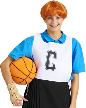 Person wearing a Sharon ginger bowl cut wig, netball uniform with a 'C' and holding a basketball on a white background