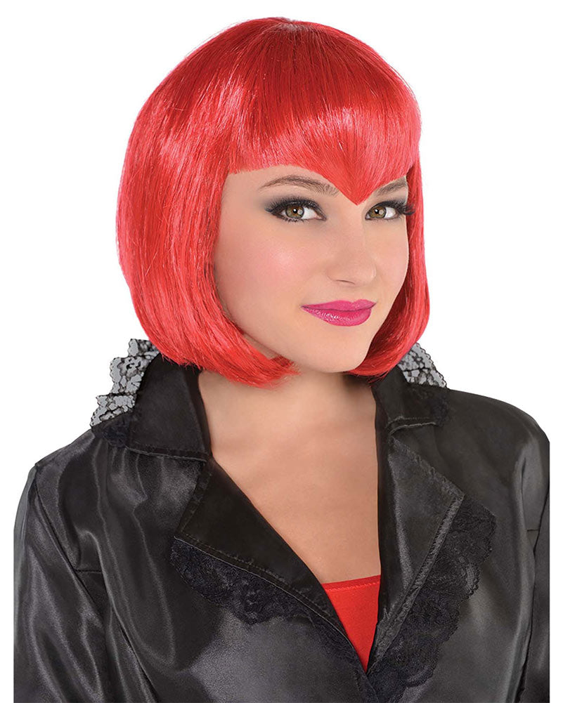 A bright red bob wig with a v-shaped fringe, modeled on a person wearing a black satin jacket over a red top, against a plain white background.