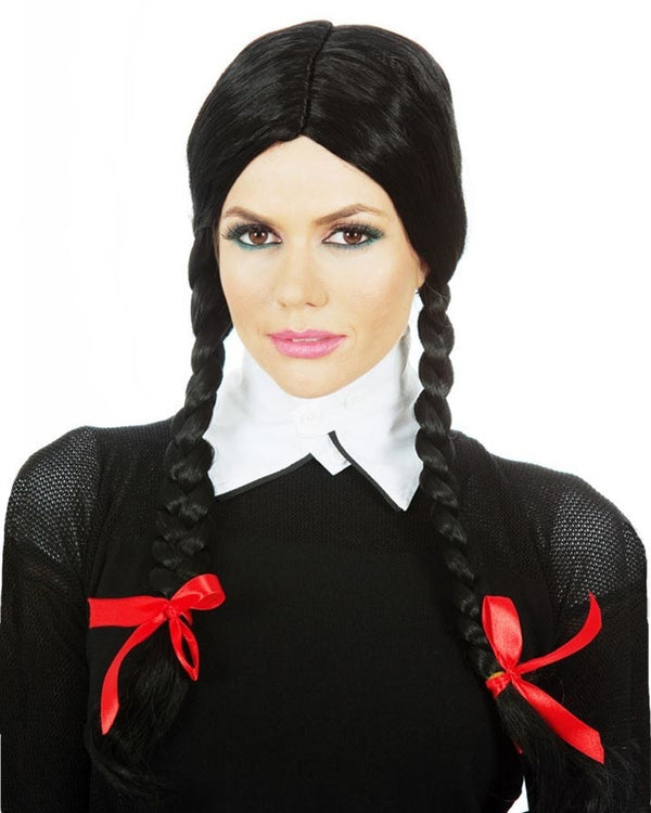Image of woman wearing black plaits Wednesday wig with red bows.
