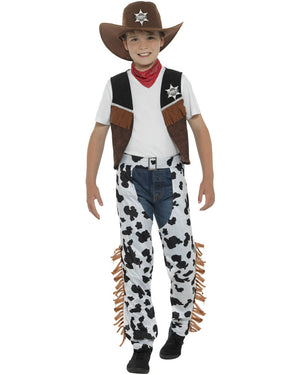Image of boy wearing cowboy costume with spotted chaps, vest and hat.