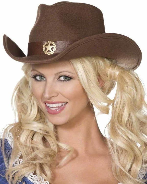 Image of woman wearing brown cowboy hat with gold star in middle. 