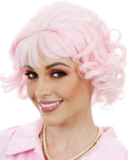 Image of woman wearing light pink Grease Frenchie style wig. 