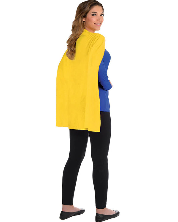 Image of woman wearing black pants, blue top and yellow superhero cape,